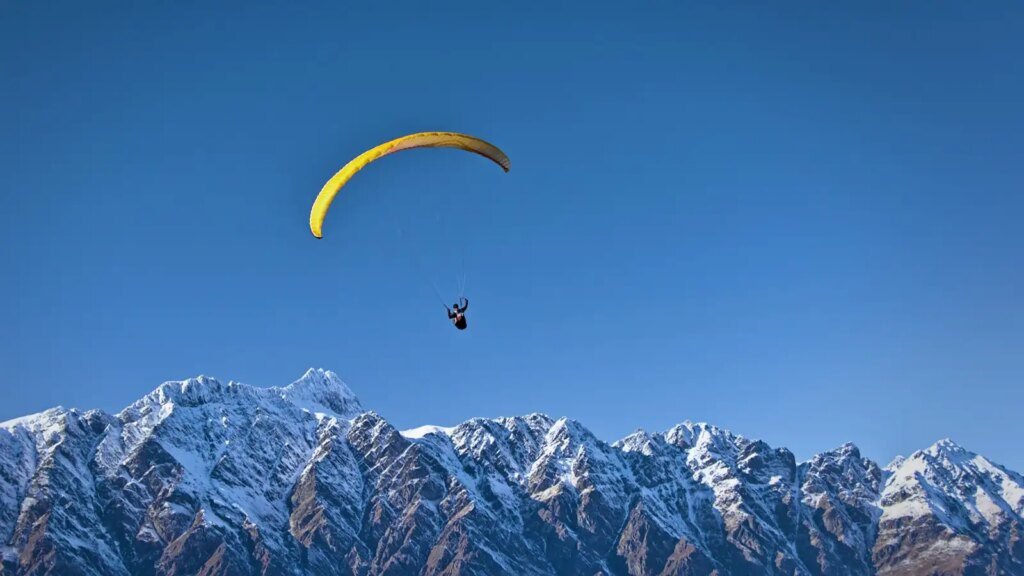 man on parachute near the mountain