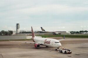 Two airplanes at an airport, showcasing commercial aviation on the tarmac.